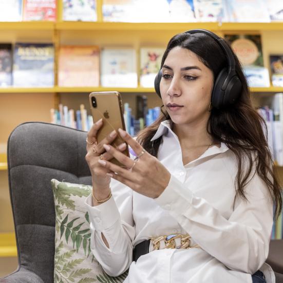 Kvinde lytter til en lydbog på biblioteket. Fotokreditering: Nikolai Linares for Centralbiblioteket.